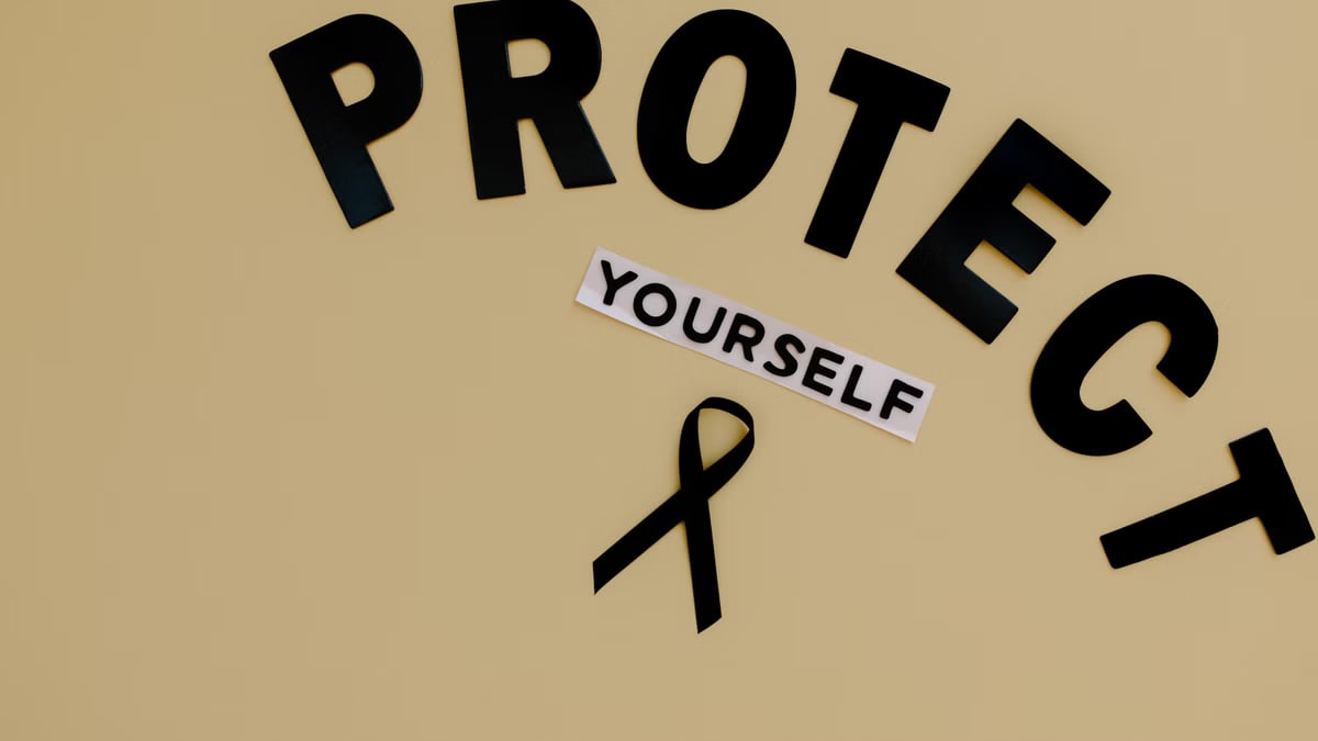 Black ribbon on yellow background with text advocating self-protection and awareness.